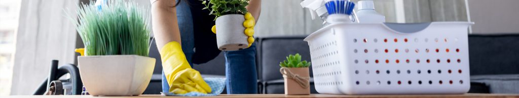 someone cleaning table with cleaning supplies on the table