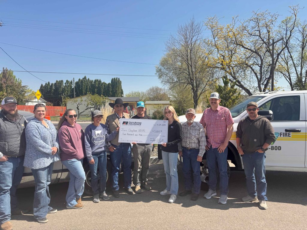 Volunteers from the Owyhee Creek RFPA accept a $5,000 donation from Audrey Egan, Marketing Specialist at Farm Bureau Insurance Company of Idaho.