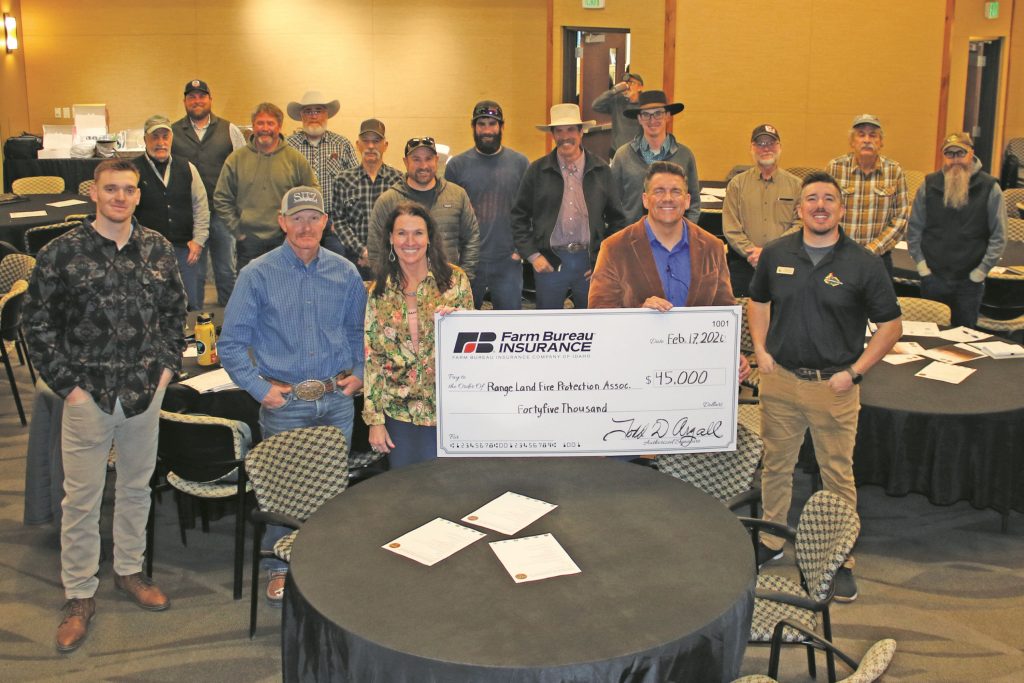 community involvement, volunteer fire protection group receiving check from Idaho team